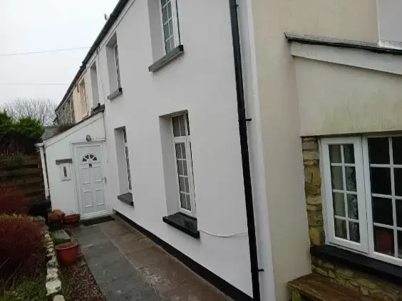 A solid wall terraced house in South Wales upgraded with crisp white external wall insulation and silicone rendering to reduce heat loss